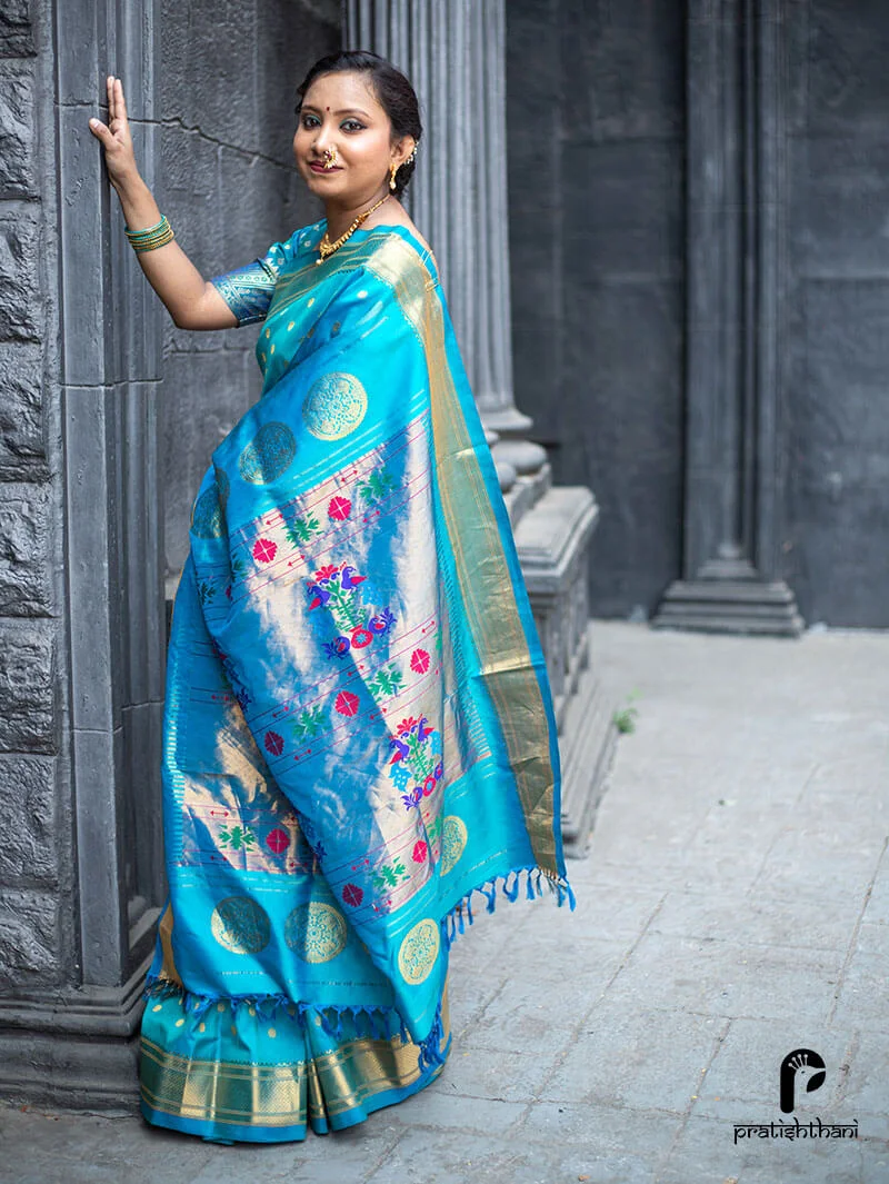 Sky blue Kalanjali Paithani saree with gold zari work, perfect for weddings