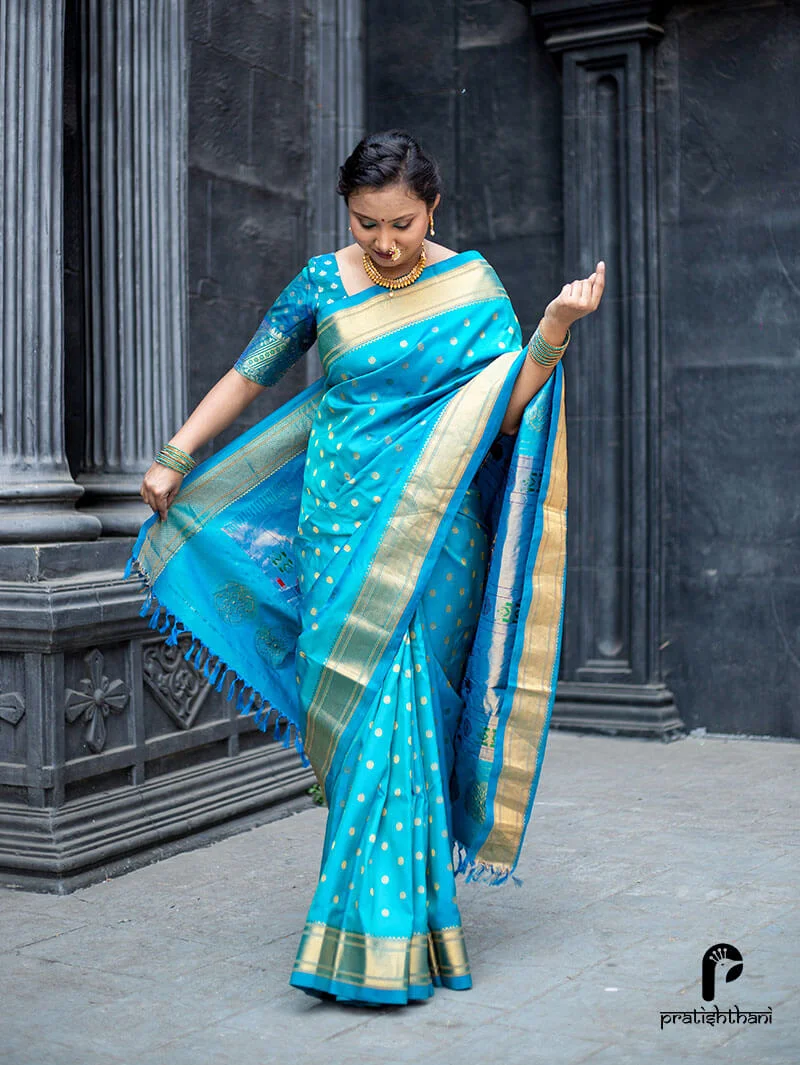 Stunning sky blue silk Kalanjali Paithani saree with a golden border and peacock motifs.