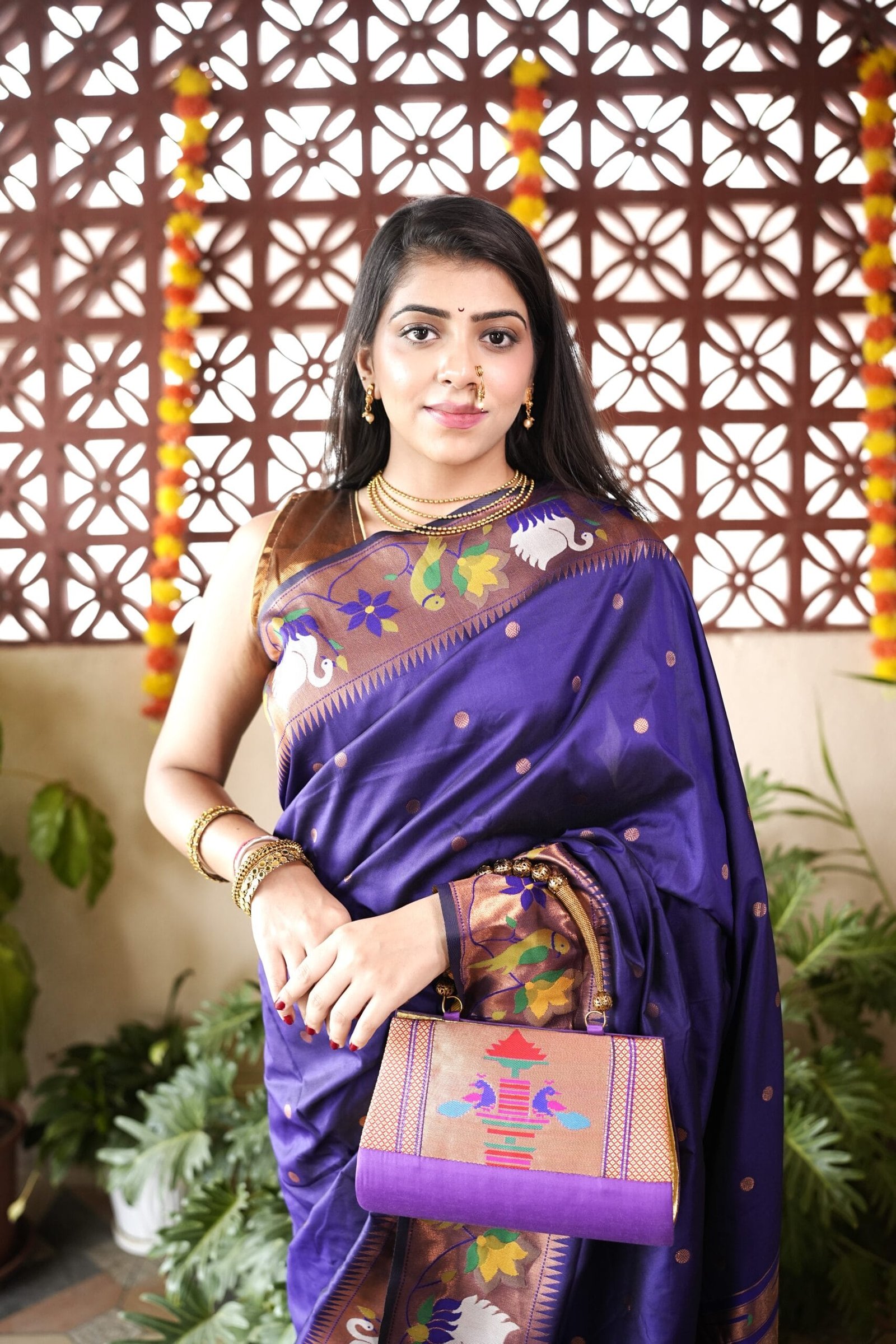 Purple Paithani handbag with traditional woven motifs